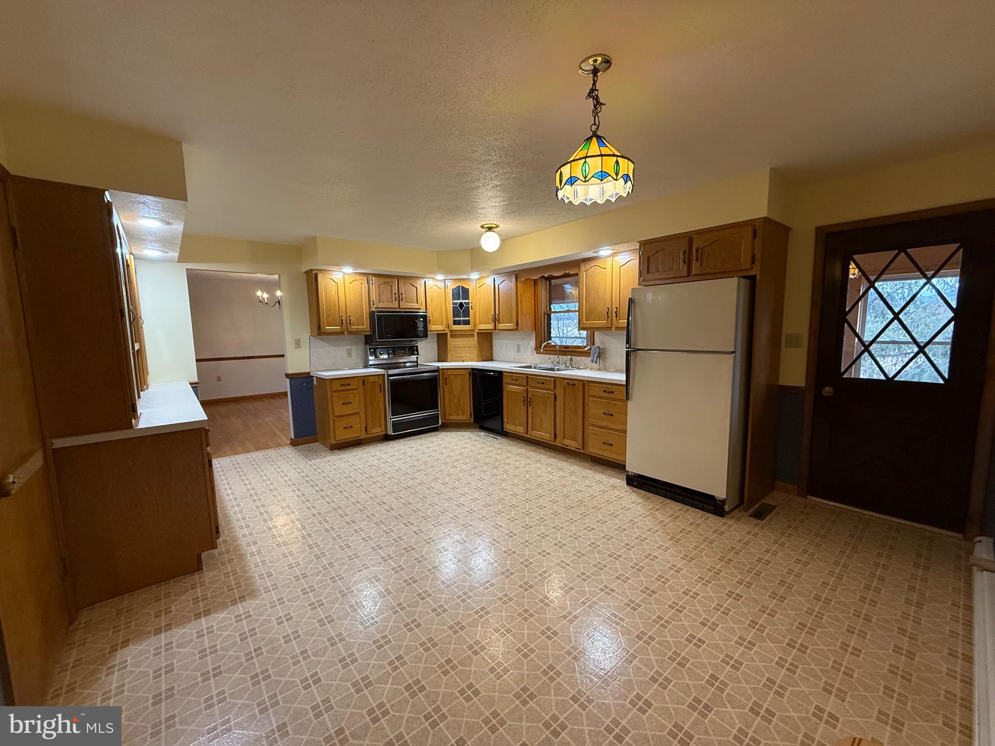 992 Silver Lane Berkeley Springs, WV 25411 - Photo 3 of 44 a kitchen with refrigerator and window