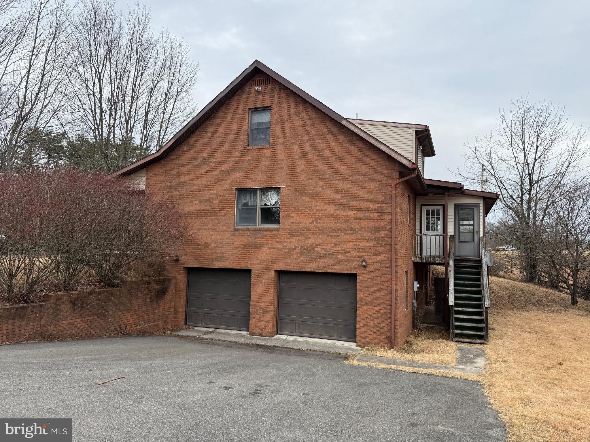 992 Silver Lane Berkeley Springs, WV 25411 - Photo 32 of 44 a front view of a house with a yard and garage
