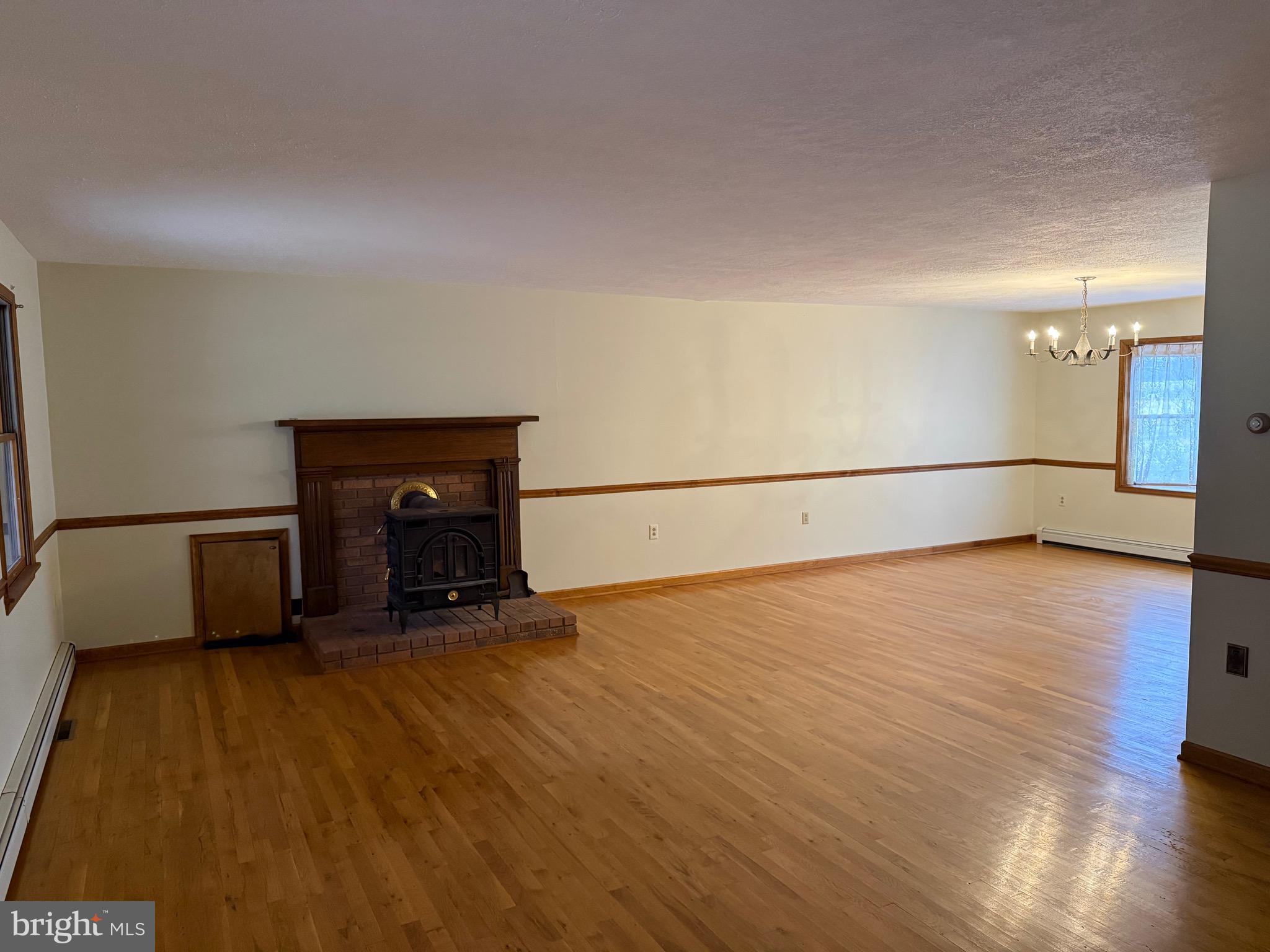 992 Silver Lane Berkeley Springs, WV 25411 - Photo 9 of 44 a view of an empty room with a fireplace