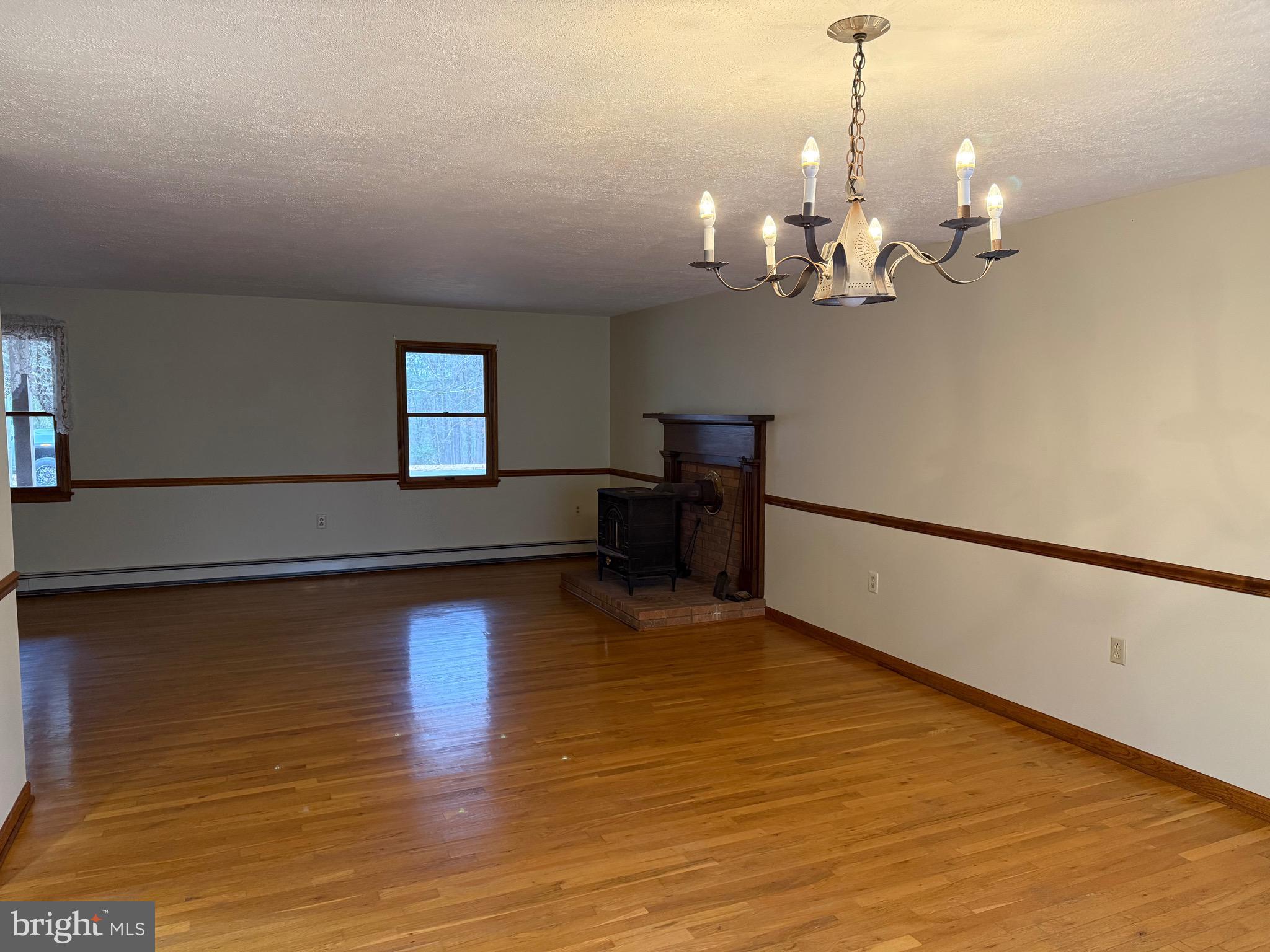 992 Silver Lane Berkeley Springs, WV 25411 - Photo 10 of 44 a view of a room with wooden floor and kitchen view