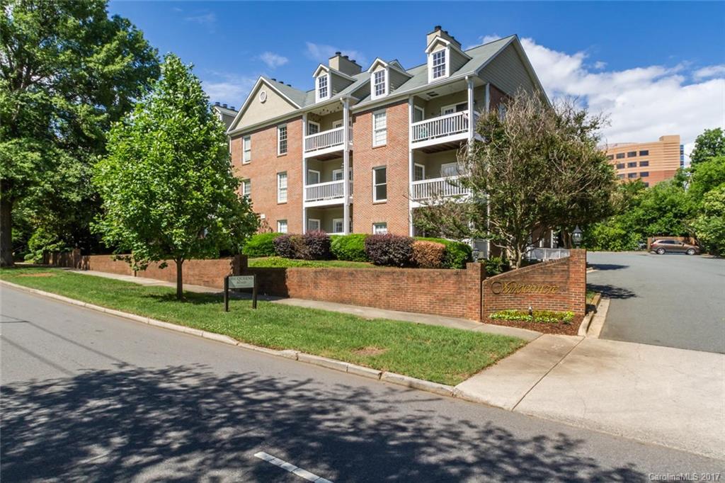 301 Queens Road, Unit 201 Charlotte, NC 28204 - Photo 2 of 24 a front view of a residential apartment building with a yard