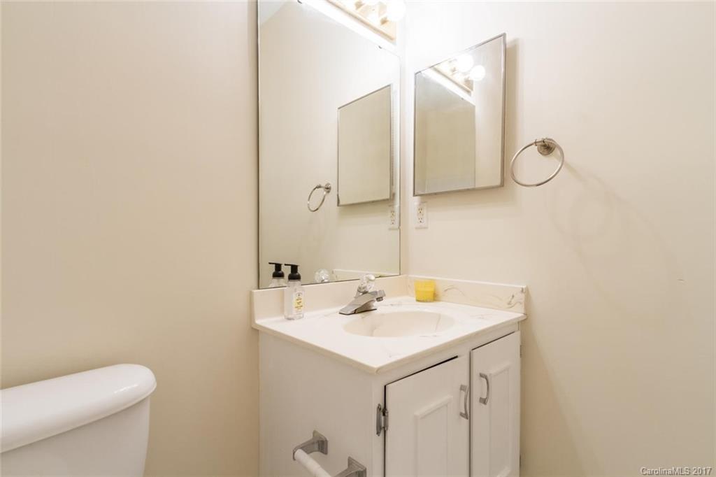 301 Queens Road, Unit 201 Charlotte, NC 28204 - Photo 13 of 24 a bathroom with a sink a toilet and a mirror