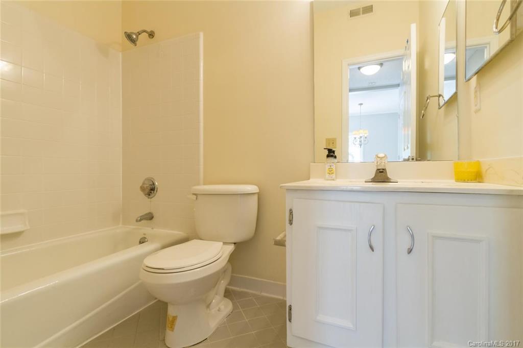 301 Queens Road, Unit 201 Charlotte, NC 28204 - Photo 14 of 24 a bathroom with a sink a toilet and shower