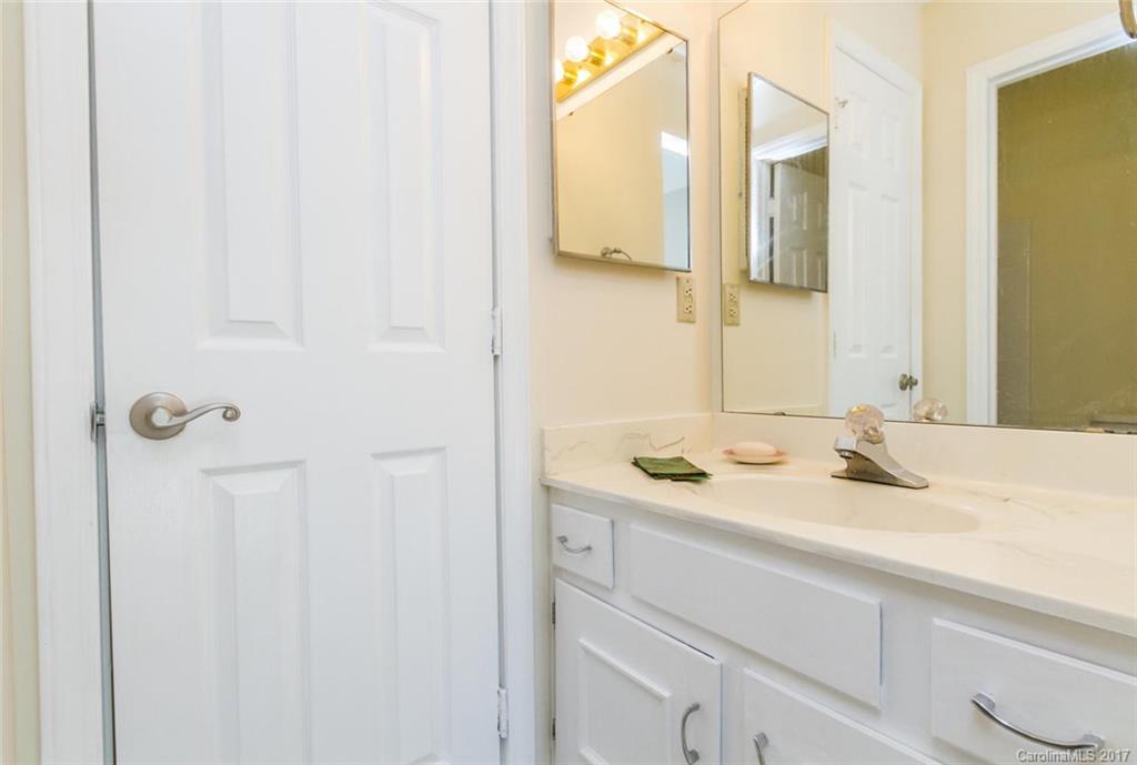 301 Queens Road, Unit 201 Charlotte, NC 28204 - Photo 19 of 24 a bathroom with a sink and a mirror