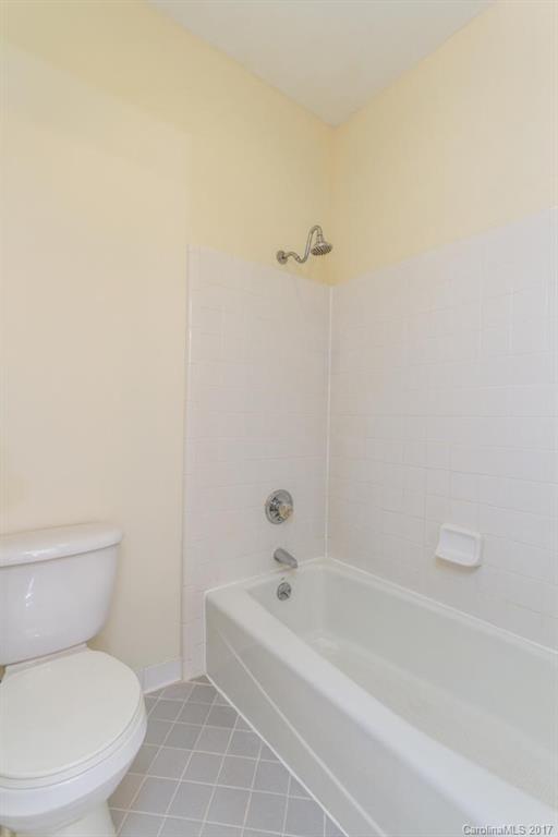 301 Queens Road, Unit 201 Charlotte, NC 28204 - Photo 20 of 24 a white toilet sitting next to a bath tub
