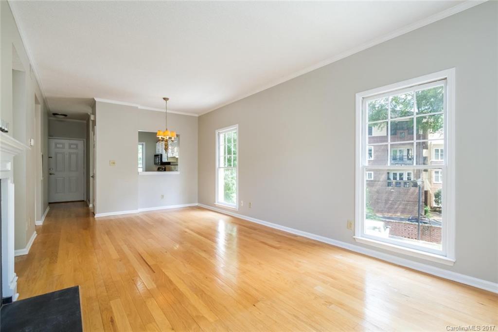 301 Queens Road, Unit 201 Charlotte, NC 28204 - Photo 4 of 24 a view of empty room with wooden floor and fan