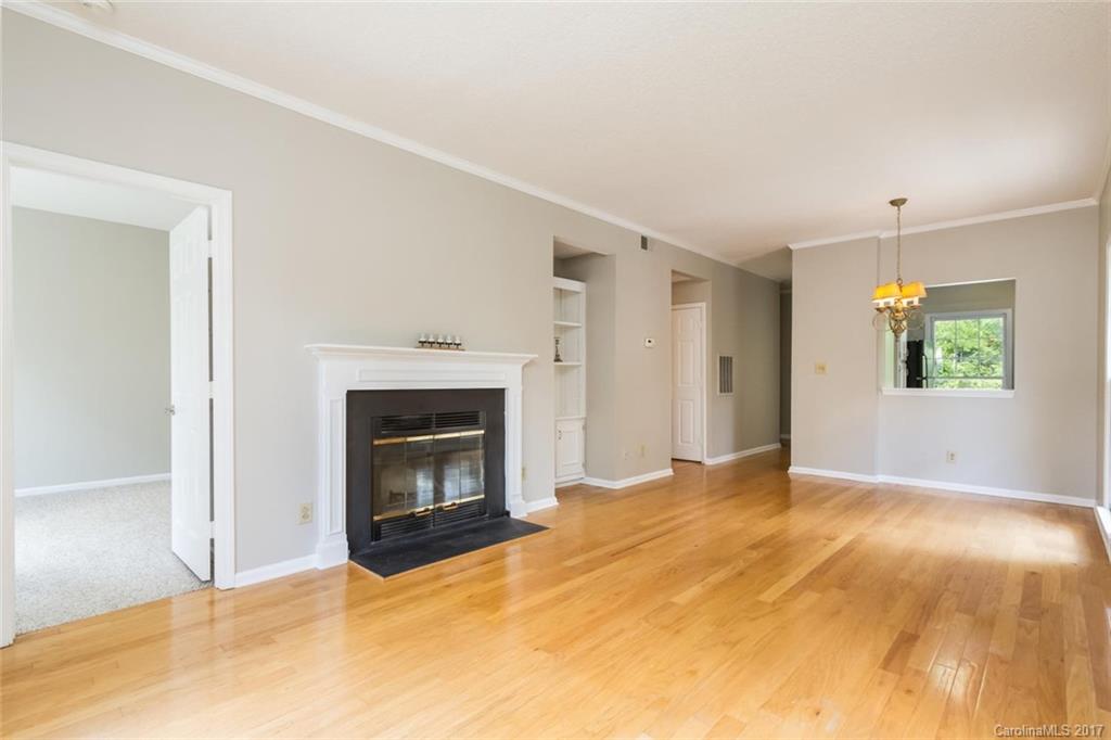 301 Queens Road, Unit 201 Charlotte, NC 28204 - Photo 5 of 24 a view of an empty room with a fireplace