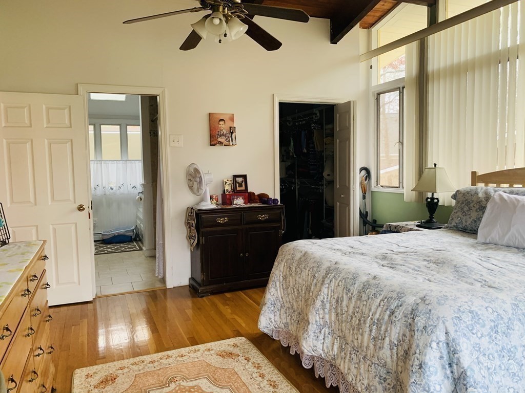 10 Bunker Circle Sandwich, MA 02563 - Photo 12 of 19 a bedroom with a bed and a chandelier