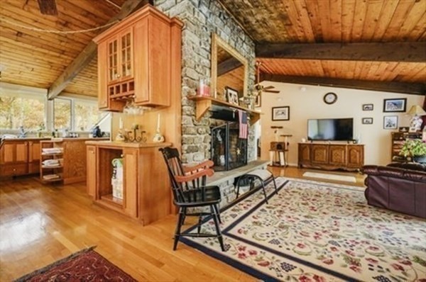 10 Bunker Circle Sandwich, MA 02563 - Photo 6 of 19 a living room with furniture a flat screen tv and a table