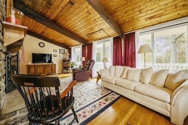 10 Bunker Circle Sandwich, MA 02563 - Photo 9 of 19 a living room with furniture a flat screen tv and a table