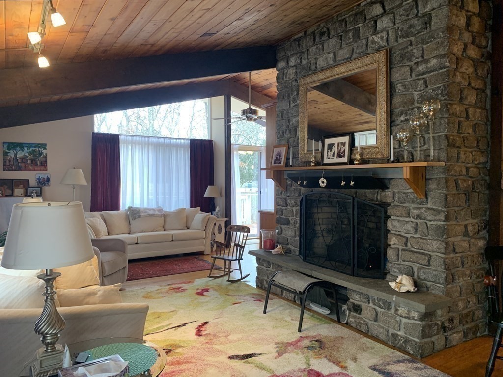 10 Bunker Circle Sandwich, MA 02563 - Photo 10 of 19 a living room with furniture and a fireplace