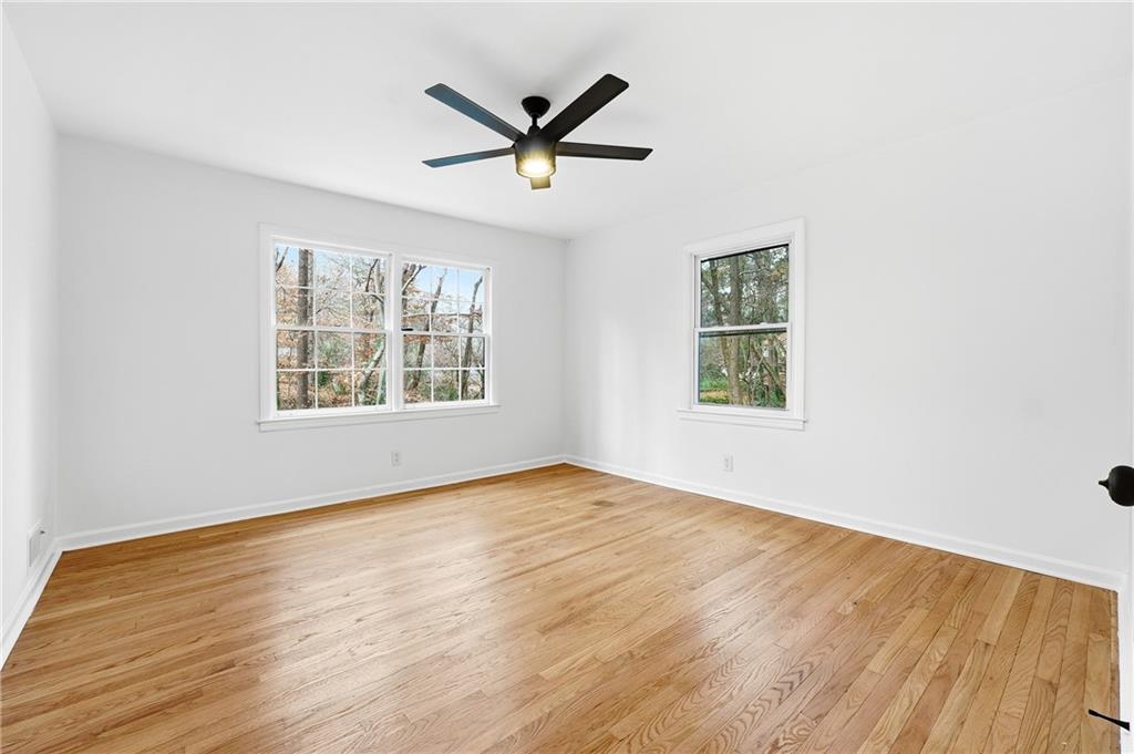 2520 Overlook Way Northeast Atlanta, GA 30345 - Photo 23 of 31 an empty room with wooden floor windows and ceiling fan