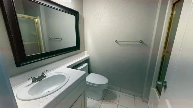 a bathroom with a glass shower door