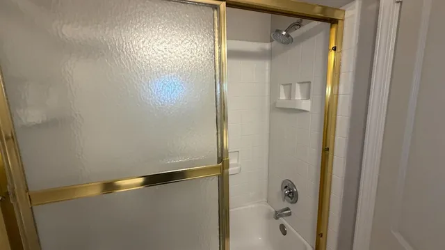 an empty room with a chandelier fan