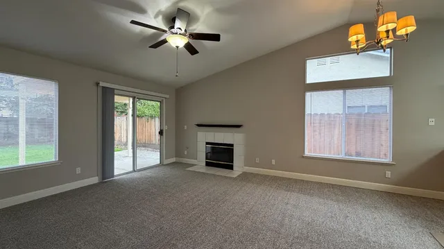 wooden floor fireplace and windows in an empty room