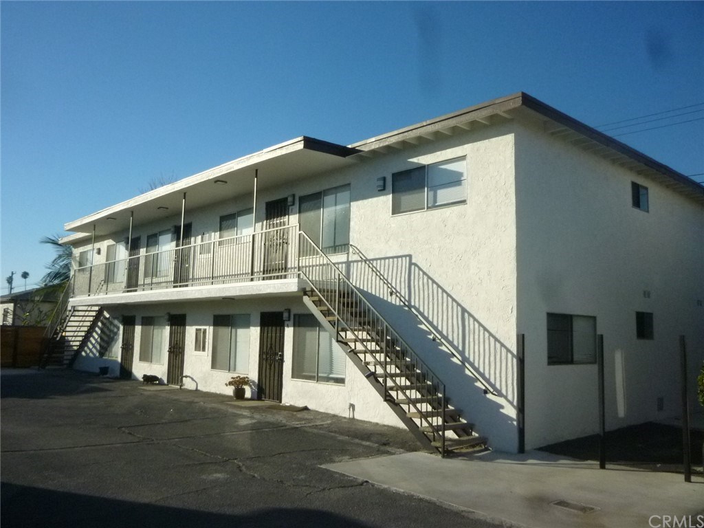 Six unit building with three units downstairs and 3 units upstairs.  Unit F is an upstairs end unit (right side).
