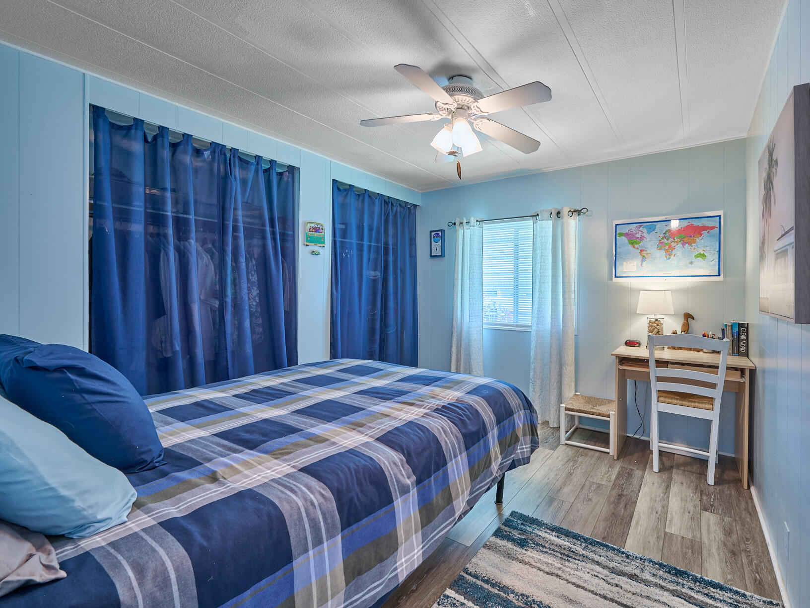 6977 Southeast Delegate Street Hobe Sound, FL 33455 - Photo 35 of 60 a bedroom with a bed and a chandelier