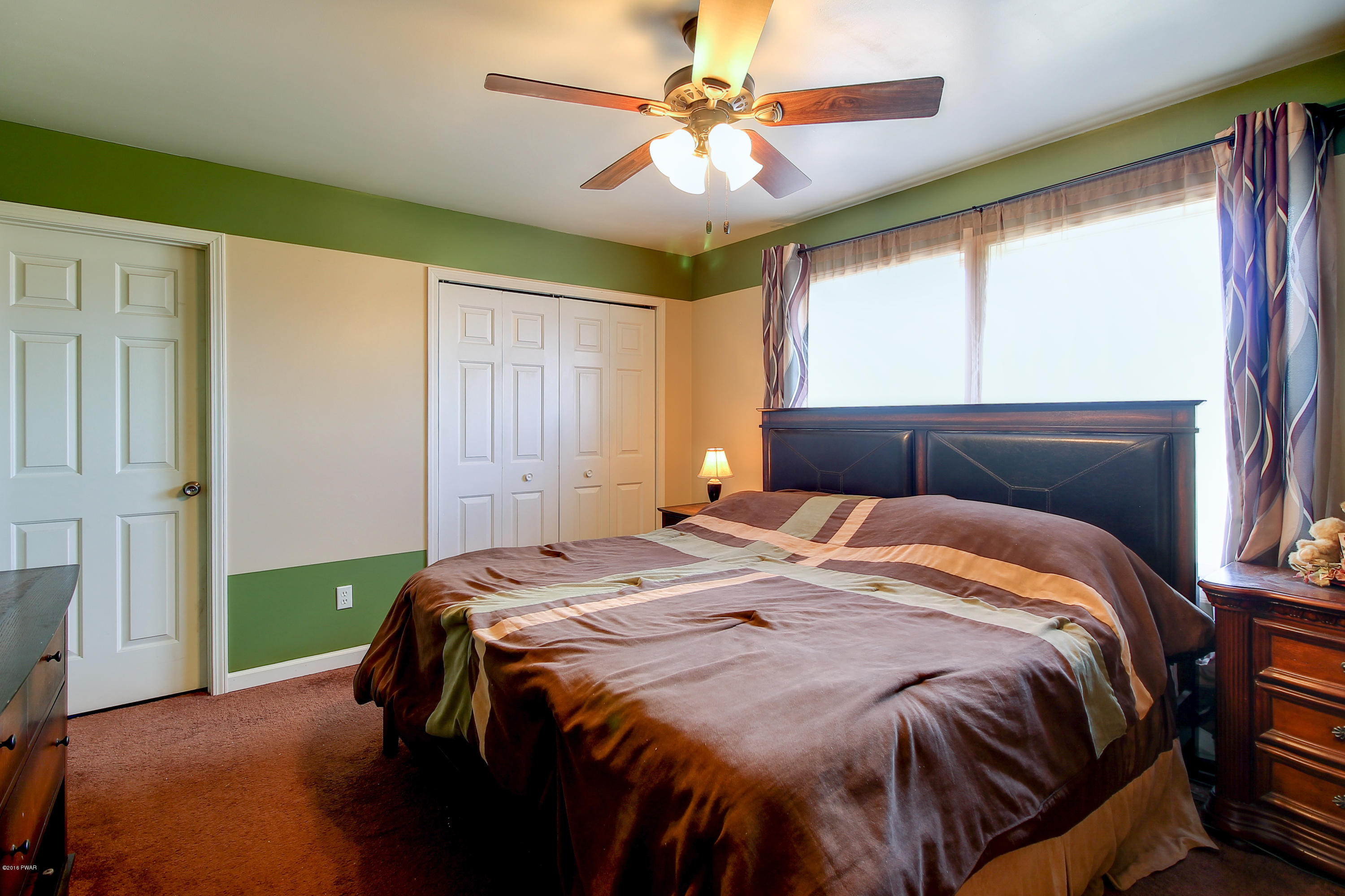 5630 Haas Pond Road Moscow, PA 18444 - Photo 17 of 42 a bedroom with a bed and window