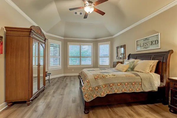 a bedroom with a bed and a chandelier