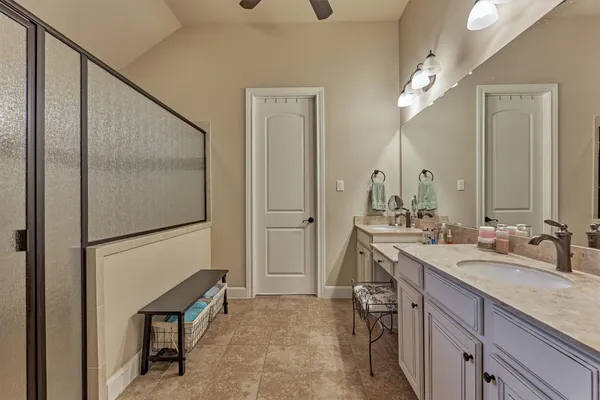 a bathroom with a granite countertop sink and a toilet