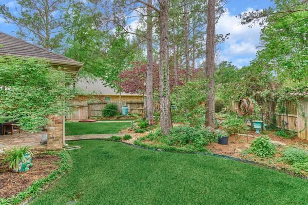 a garden with trees in the background