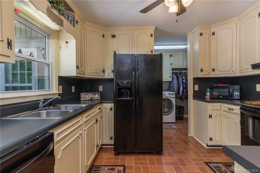 4600 Maple Creek Road Rutherfordton, NC 28139 - Photo 14 of 45 a kitchen with stainless steel appliances granite countertop a refrigerator a sink and white cabinets