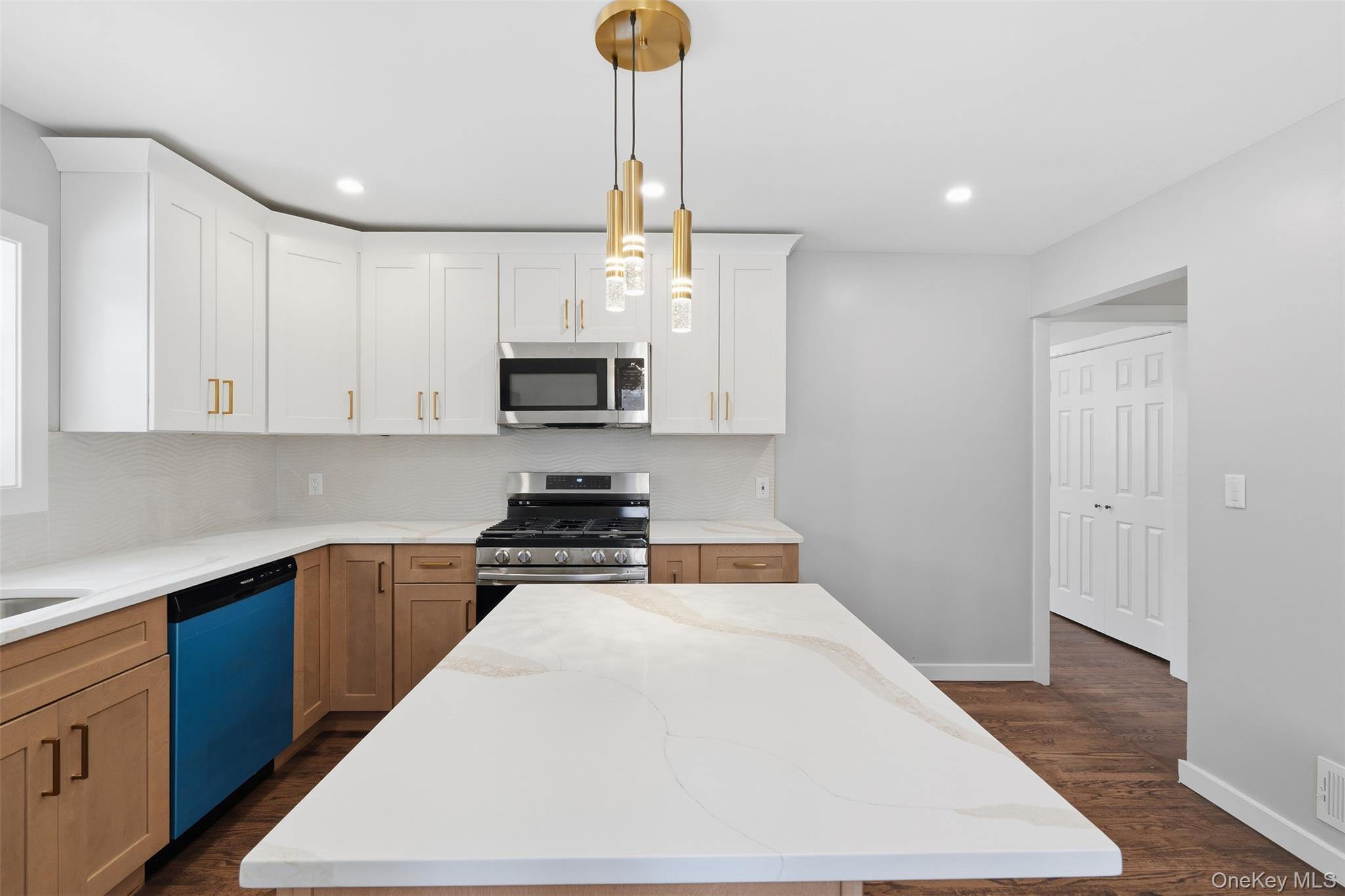 21 Janet Place Stony Point, NY 10980 - Photo 12 of 31 a kitchen with stainless steel appliances a stove a sink and white cabinets
