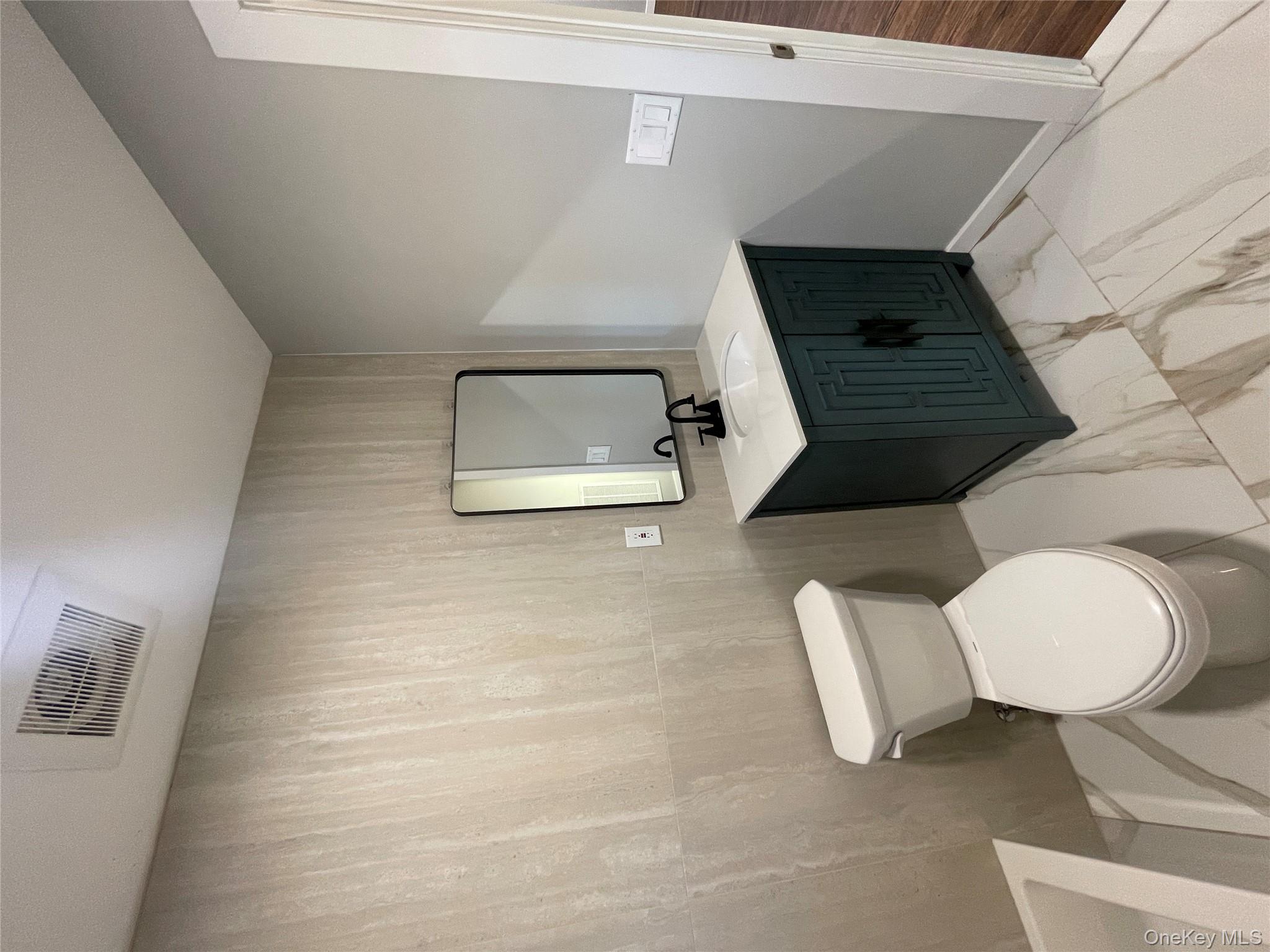 21 Janet Place Stony Point, NY 10980 - Photo 14 of 31 a bathroom with a toilet a sink and mirror