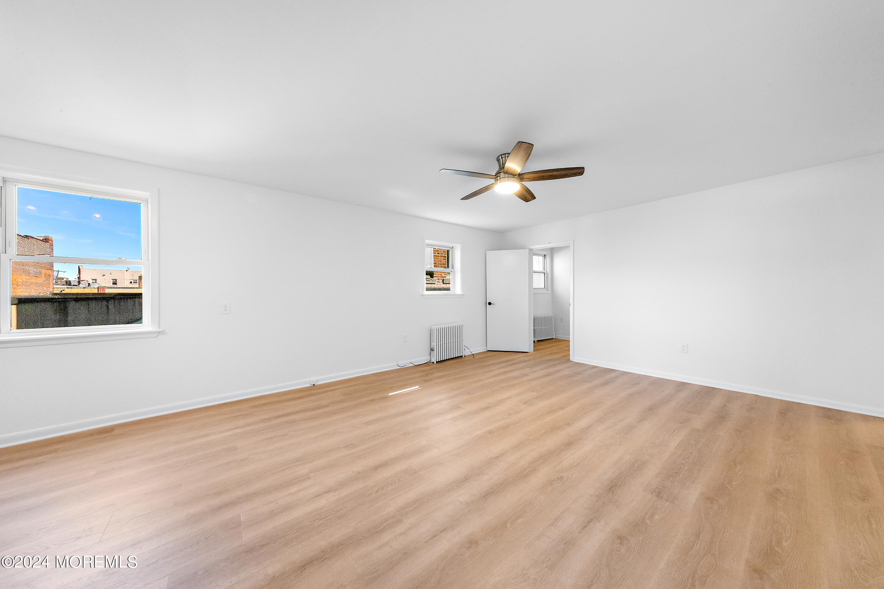 a view of empty room with ceiling fan