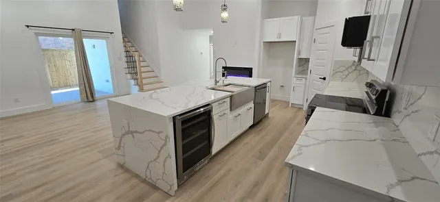 a kitchen with stainless steel appliances a stove microwave and a refrigerator
