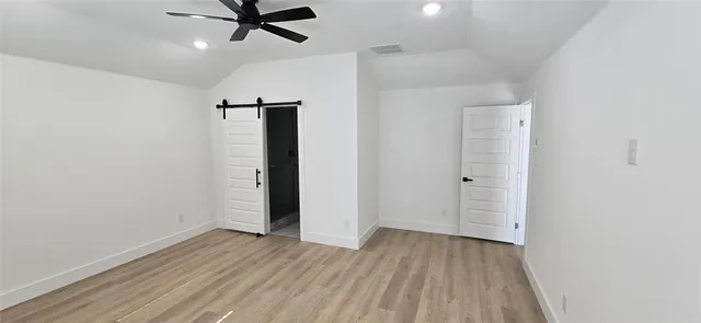 an empty room with wooden floor a ceiling fan and closet