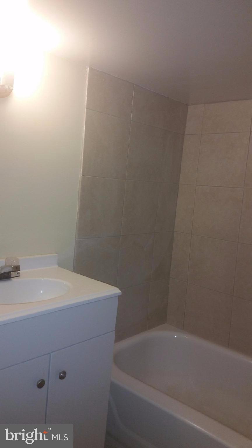 603 East 36th Street Baltimore, MD 21218 - Photo 22 of 29 a bathroom with a sink and vanity
