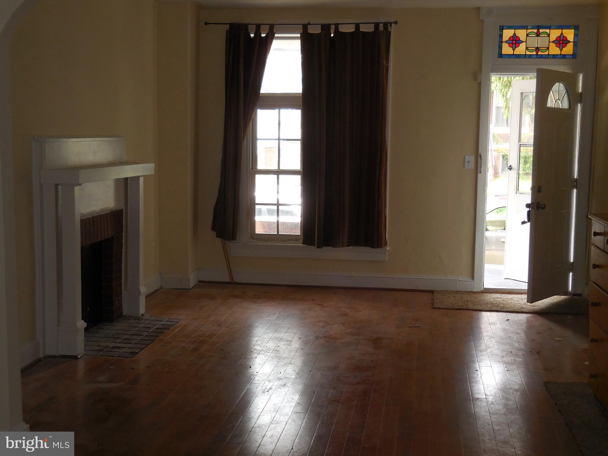 603 East 36th Street Baltimore, MD 21218 - Photo 6 of 29 a view of an empty room with wooden floor and a window