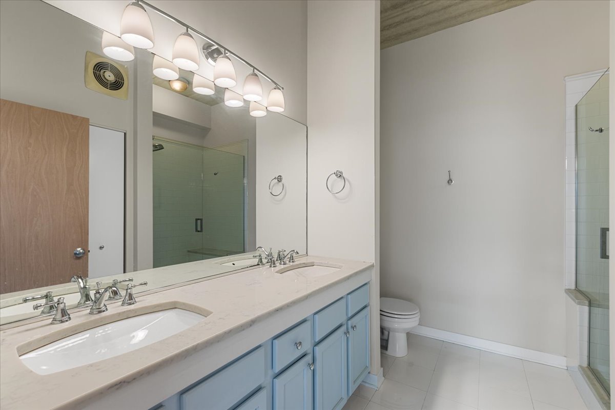3260 North Clark Street, Unit 306 Chicago, IL 60657 - Photo 13 of 17 a bathroom with a sink a toilet and shower