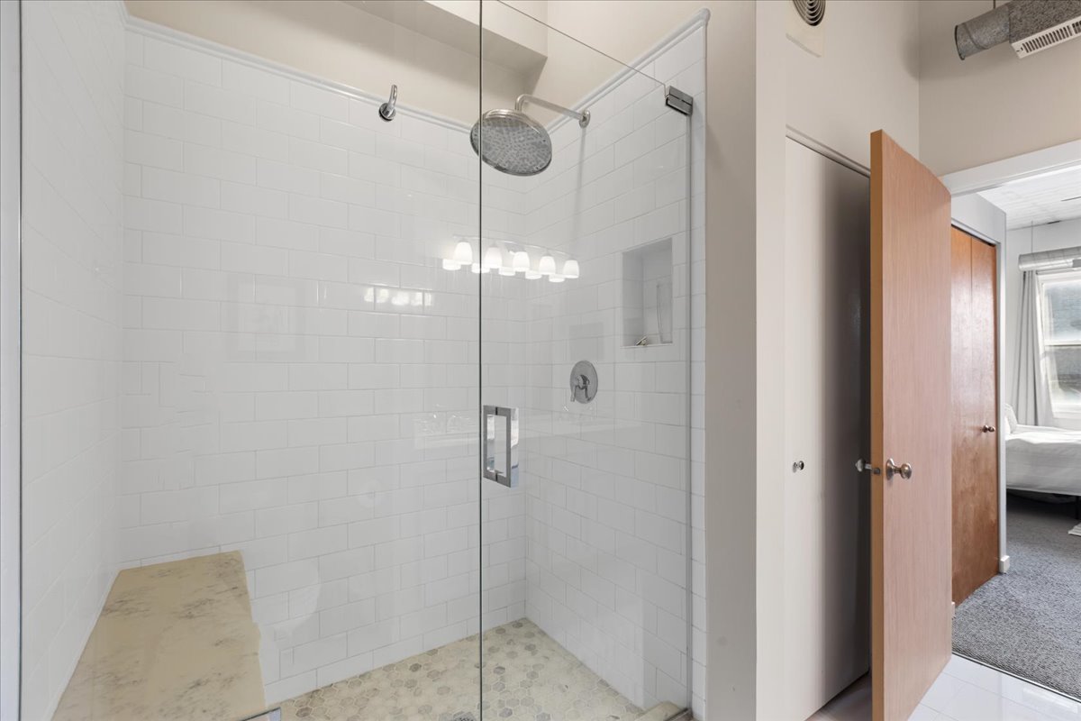 3260 North Clark Street, Unit 306 Chicago, IL 60657 - Photo 14 of 17 a bathroom with a glass shower door