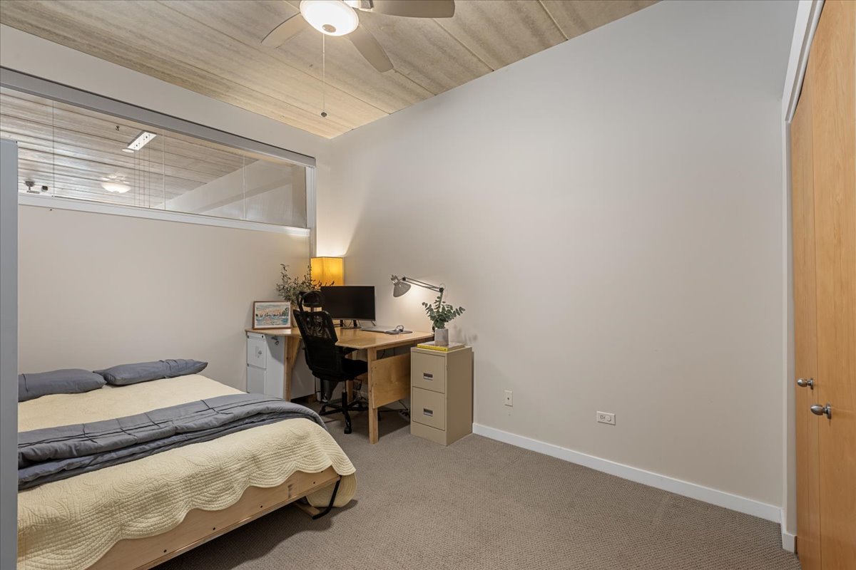 3260 North Clark Street, Unit 306 Chicago, IL 60657 - Photo 15 of 17 a bedroom with a bed and a table