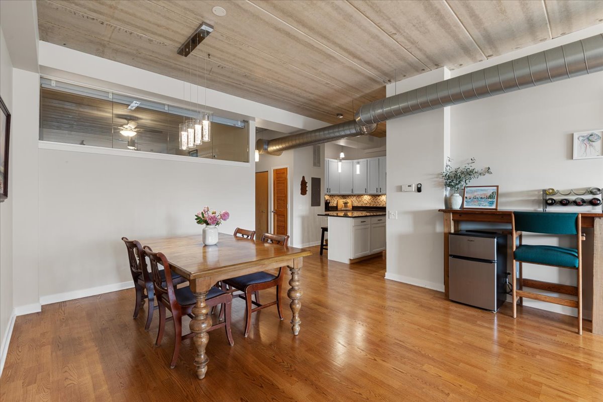 3260 North Clark Street, Unit 306 Chicago, IL 60657 - Photo 2 of 17 a view of a dining room with furniture and wooden floor