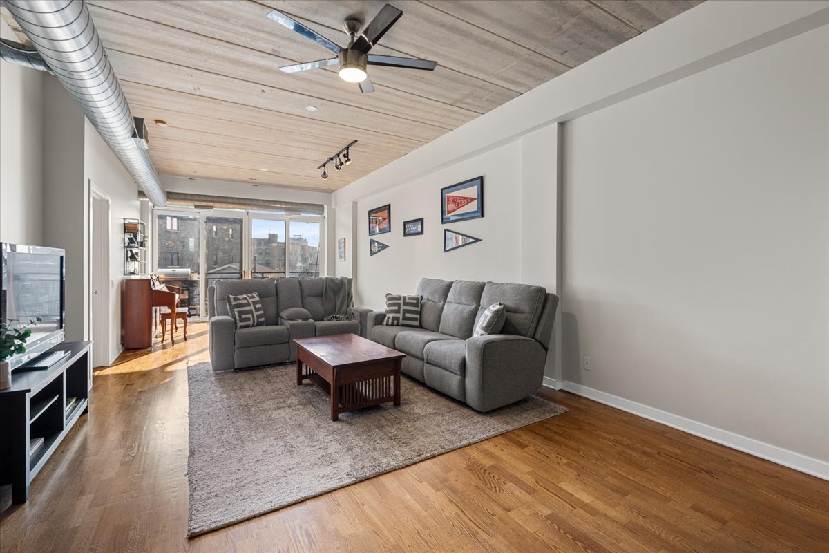 3260 North Clark Street, Unit 306 Chicago, IL 60657 - Photo 6 of 17 a living room with furniture and a flat screen tv