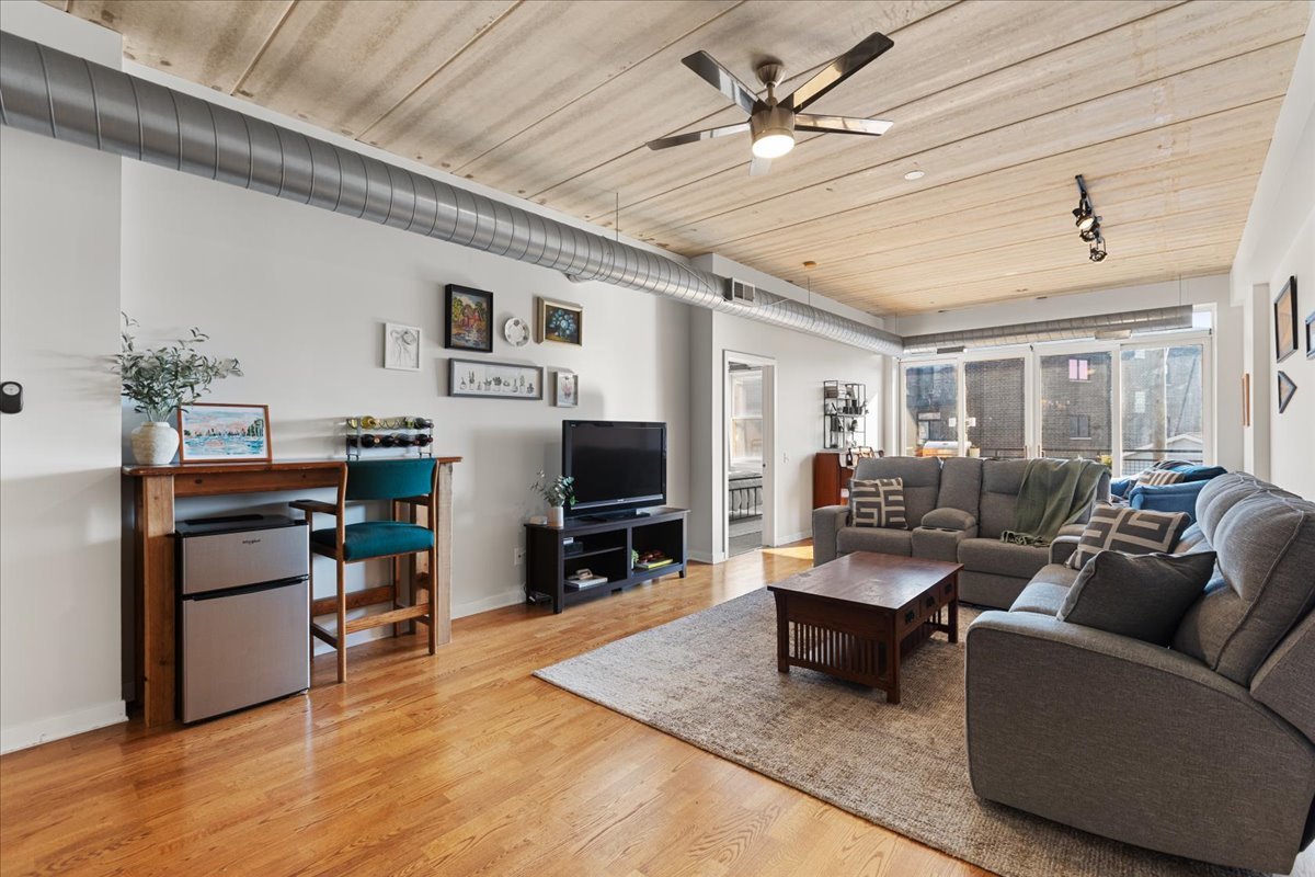3260 North Clark Street, Unit 306 Chicago, IL 60657 - Photo 7 of 17 a living room with furniture and a flat screen tv