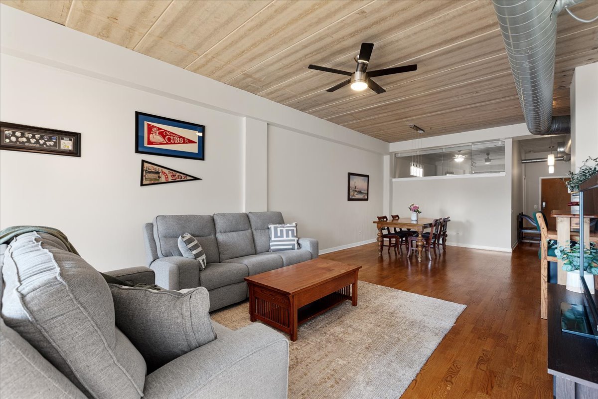 3260 North Clark Street, Unit 306 Chicago, IL 60657 - Photo 8 of 17 a living room with furniture and wooden floor