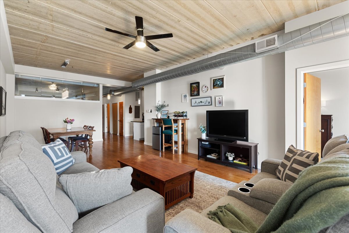 3260 North Clark Street, Unit 306 Chicago, IL 60657 - Photo 9 of 17 a living room with furniture and a flat screen tv