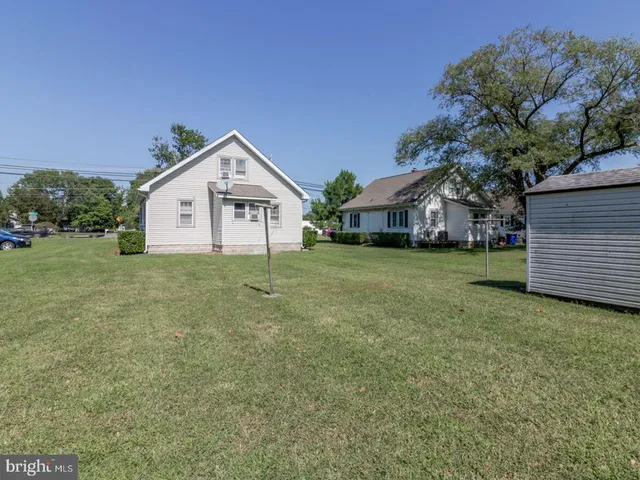 a front view of a house with yard and green space