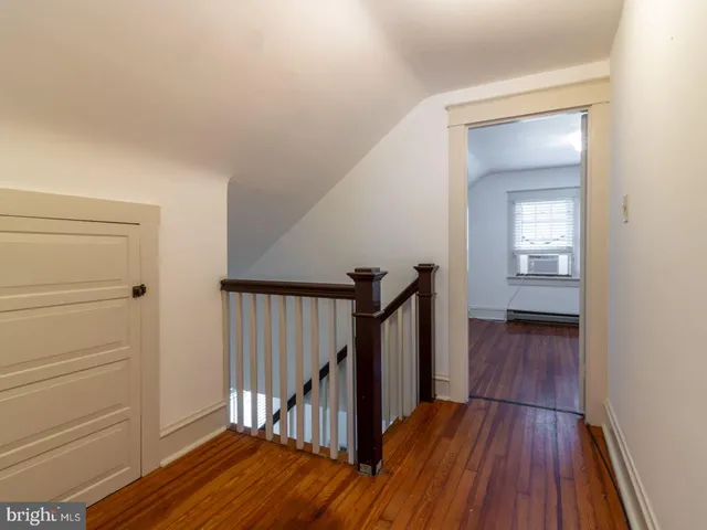 a view of a hallway view with wooden floor and staircase