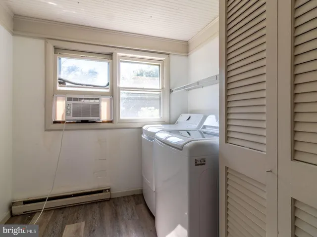 a bathroom with a granite countertop sink and a window