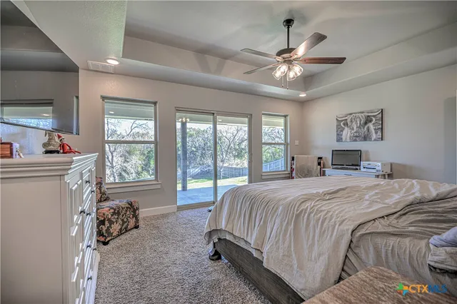 a bedroom with a bed and ceiling fan