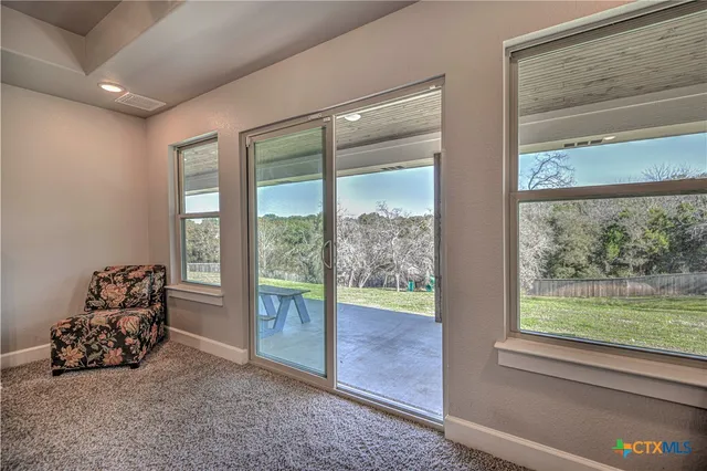 a room with furniture and a floor to ceiling window