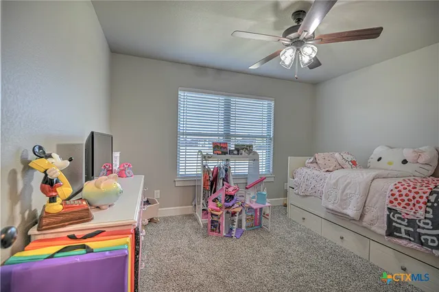 a bedroom with bed and a chandelier