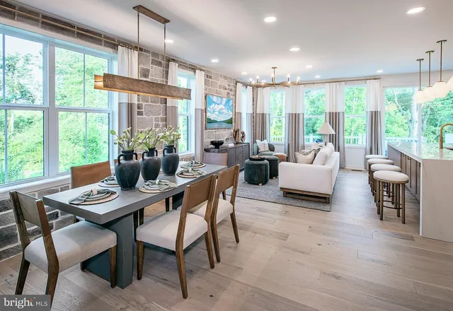 a dining room with furniture a chandelier and wooden floor