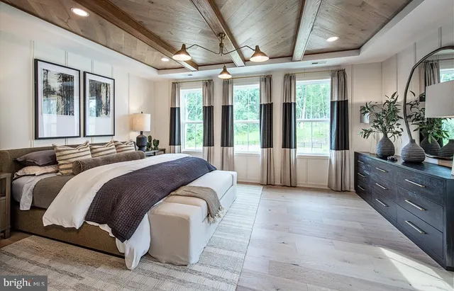 a spacious bedroom with a large bed and windows