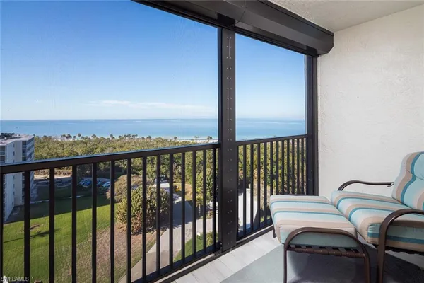 a view of a balcony with furniture